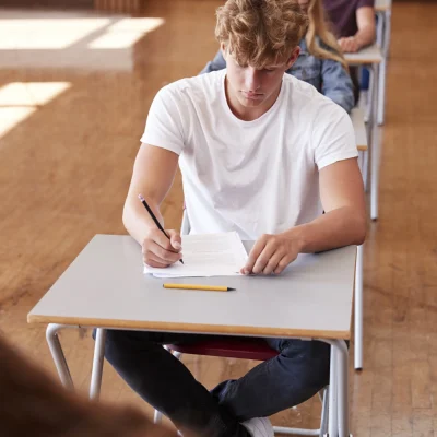 group-of-teenage-students-sitting-examination